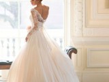 a classy princess style wedding dress with a plain and lace bodice with long sleeves and a pleated layered skirt with a train is a gorgeous idea for a refined wedding with a touch of vintage