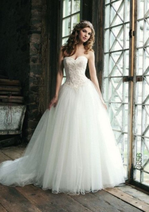 a princess style strapless wedding dress with a lace applique bodice, a full layered skirt with a train is a dreamy idea for a modern fairy-tale wedding