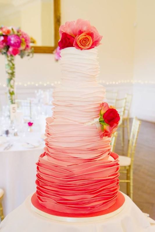 an ombre white to pink wedding cake with fresh bright blooms is a bold and cool idea for a modern bold wedding