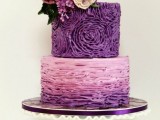 a textural purple wedding cake with a floral and an ombre ruffle tier plus fresh blooms and leaves on top