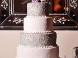 a lilac wedding cake with plain and glitter tiers, bright blooms and feathers is a refined and chic dessert idea