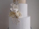 a refined wedding cake with a beaded and patterned lace tier, with sugar blooms and beads