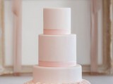a blush wedding cake with ribbons and a floral ruffle tier is very romantic and very girlish