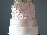 a refined wedding cake with striped tiers, floral ones in gold, white and pink