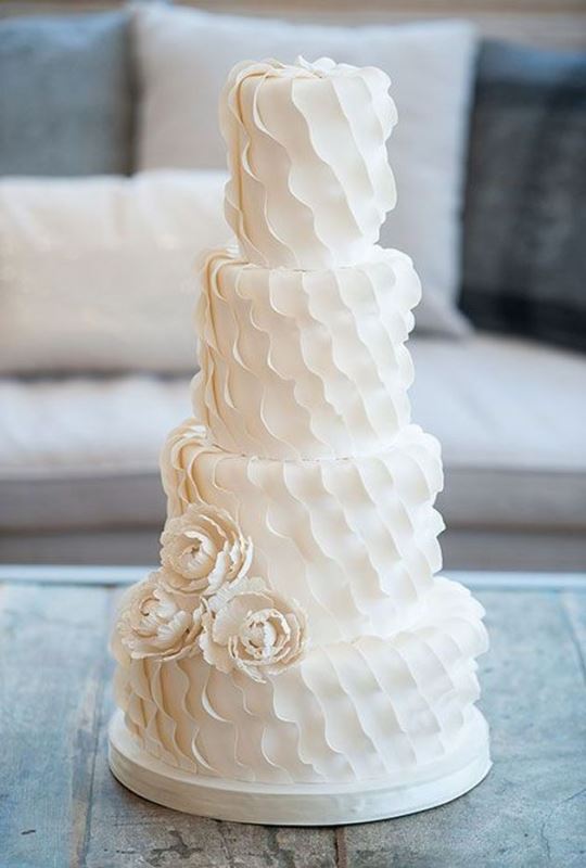 a white textural with ruffles and sigar blooms is a romantic and whimsical dessert idea