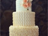 a mint and neutral wedding cake with stripes, scallops, ruffles, sugar blooms and pearls is very romantic