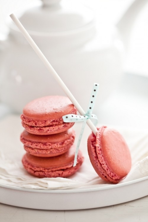 coral macarons and macarons on sticks can be served at the wedding with a pretty and cool color scheme
