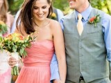 a draped coral strapless wedding dress, a gold and coral wedding bouquet in a creamy wrap for a chic and cool look