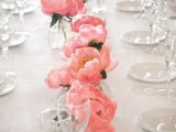 coral blooms lining up the table are a nice table runner or centerpiece in bold colors, it’s simple and natural