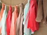 mint, coral and taupe wedding garland with tassels is a cool and creative idea for a wedding