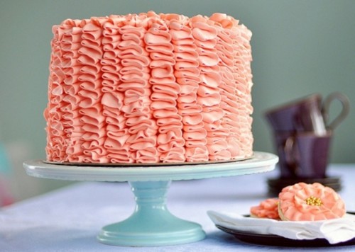 a ruffle coral wedding cake on a mint stand is a cool idea for a wedding with such a color scheme