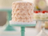 a creamy swirl wedding cake on a mint stand is a cool idea for cream, mint and coral wedding