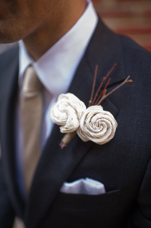 a creative wedding boutonniere of branches and fabric flowers is a very chic and eye catchy idea to try