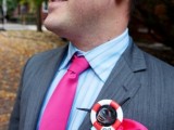 a creative wedding boutonniere of a striped life saver and some bright blue ribbon for a person whose job is connected to the sea