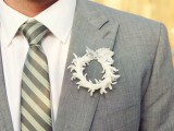 a paper flower wreath boutonniere with a bow on top is a fun and creative accessory with a touch of romance