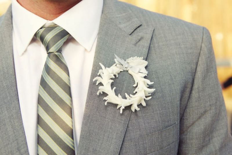 a paper flower wreath boutonniere with a bow on top is a fun and creative accessory with a touch of romance
