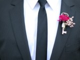 a cute and stylish boutonniere of a vintage key, a hot pink bloom and pink baby’s breath is a very cool idea