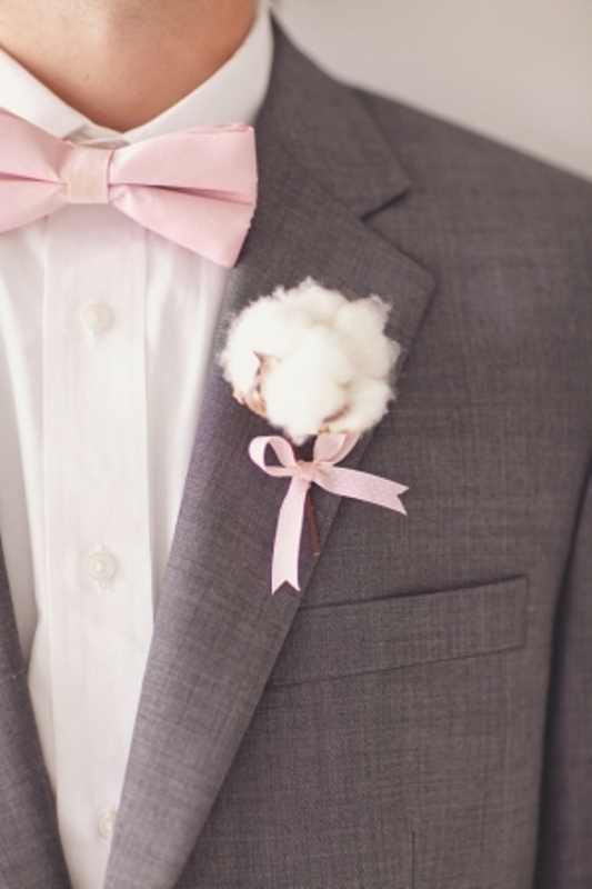 a cute cotton wedding boutonniere with a tiny pink bow that matches the bow tie looks soft, cute and very chic