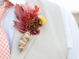 an eye-catchy fall boutonniere of fall leaves, berries, a pinecone, a billy ball wrapped with twine is cool and relaxed