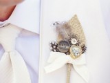 a beautiful wedding boutonniere of burlap, buttons, a heart rhinestone, feathers and a bow is a cool idea to make the groom’s look bolder and catchier