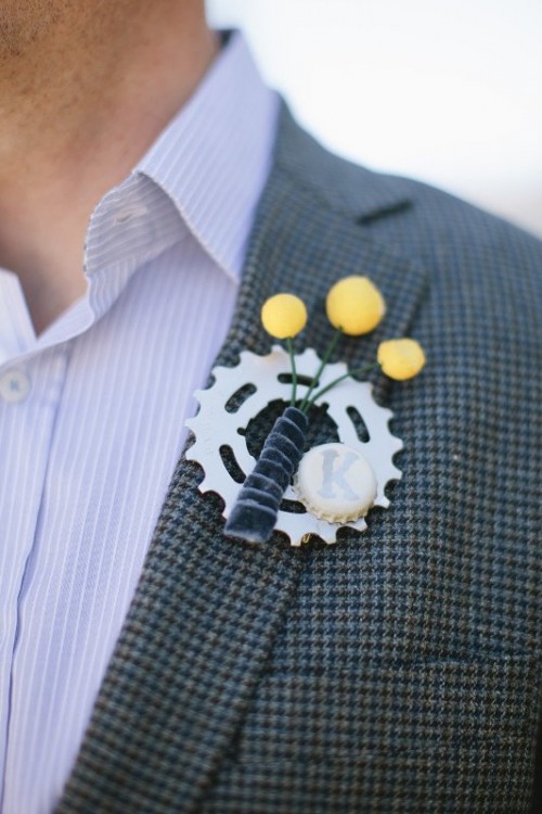 a creative wedding boutonniere composed of a gear, billy balls and a bottle cap is a fun idea that shows off what the groom likes