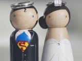 kokeshi doll cake toppers styled as a Superman and his bride are an awesome idea if you two love comics or super heroes
