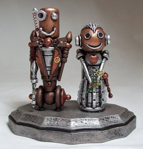steampunk metal cake toppers showing the marrying couple are a unique idea suitable for a wedding with this theme