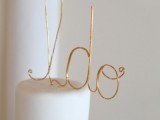 a white buttercream wedding cake with a gold calligraphy I DO cake topper is a lovely modern idea to try
