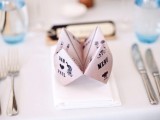 a folded paper menu is a creative idea to mark each place setting and give it a fun touch