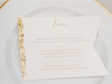 a flag with gold glitter is a creative and glam idea to mark each place setting and add a sparkle there
