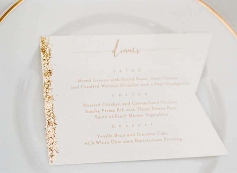 A flag with gold glitter is a creative and glam idea to mark each place setting and add a sparkle there