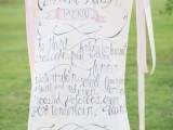 a large wedding menu with ribbons and calligraphy will act as a wedding sign and decoration