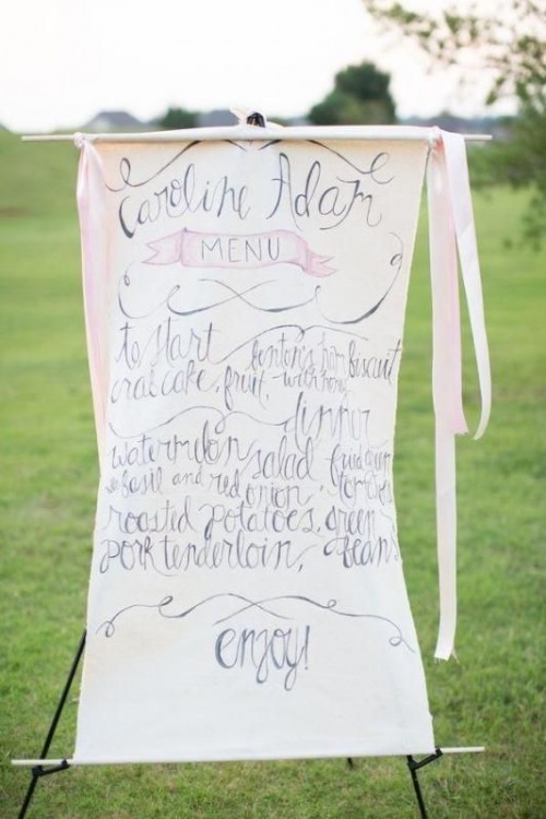 a large wedding menu with ribbons and calligraphy will act as a wedding sign and decoration