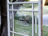 a vintage window menu hung on a tree is a great idea for a backyard or woodland wedding