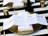 a folded menu with gold calligraphy is a stylish modern idea for a chic wedding