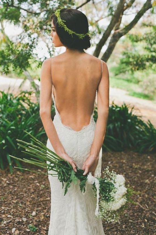 A beautiful lace mermaid wedding dress with a low back on spaghetti straps is a perfect idea for a summer boho wedding