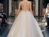 a neutral princess-style wedding dress with semi sheer embellished bodice, a low back, a full layered skirt is amazing