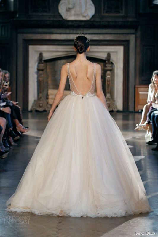 A neutral princess style wedding dress with semi sheer embellished bodice, a low back, a full layered skirt is amazing