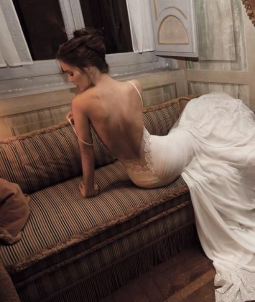 a sexy mermaid plain wedding dress with a low back with lace, spaghetti straps and an embellished train is wow
