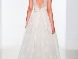 a romantic lace A-line wedding balldown with a low back on thick straps, a bow on the back and a skirt wiht a slight train