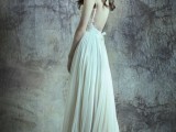 a dreamy A-line wedding dress with a lace bodice, spaghetti straps, a layered pleated skirt with a train for a boho bride