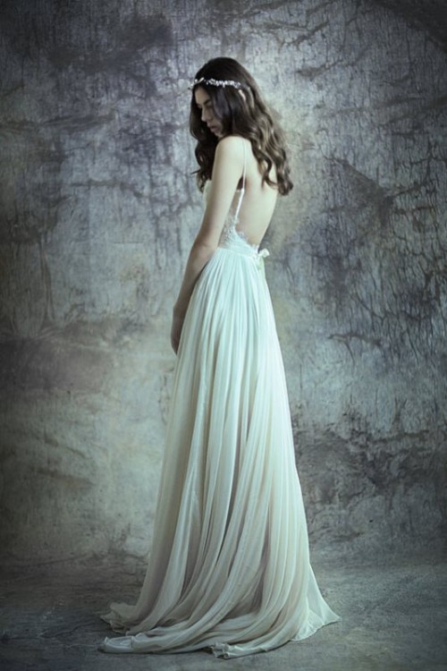 a dreamy A-line wedding dress with a lace bodice, spaghetti straps, a layered pleated skirt with a train for a boho bride