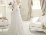 a lace embellished A-line wedding dress with a low back and short sleeves and a train is very formal and very chic