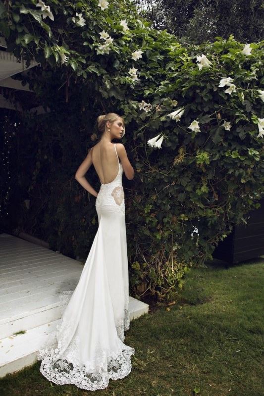 A chic plaid mermaid wedding dress with a low back, lace inserts, a train and spaghetti straps is gorgeous