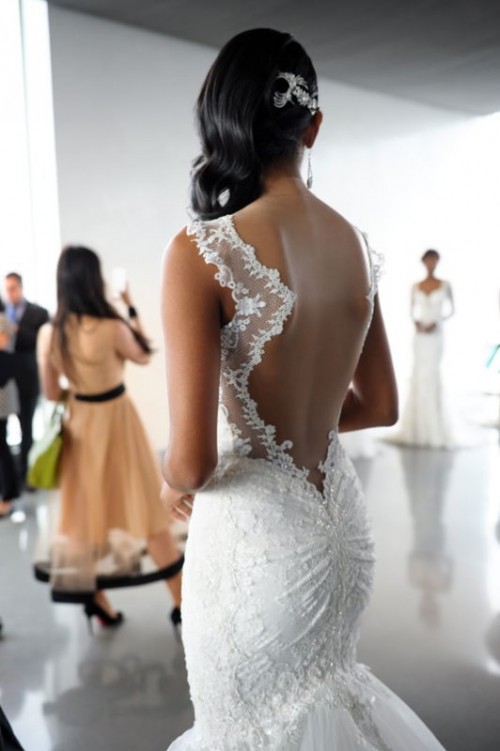 accent your curves with a lace embellished mermaid wedding dress with a low back, geometric straps and a tulle tail with a train