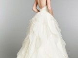 a princess-style strapless wedding dress with a low back, a ruffle full skirt with a train for a refined and formal wedding