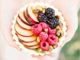 a large tartlet with raspberries, blackberries, apples and pistachios is a refined dessert for a fall wedding