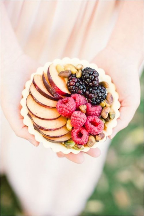 a large tartlet with raspberries, blackberries, apples and pistachios is a refined dessert for a fall wedding