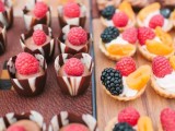 chocolate cups with fresh raspberries on top and mini tartlets with blackberries, raspberries and peach slices are amazing for a summer wedding
