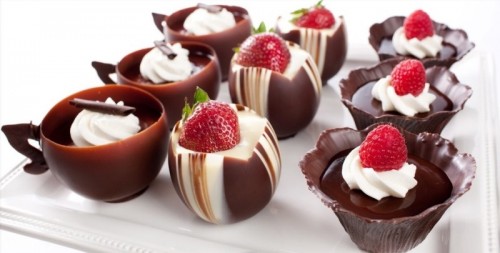 chocolate cups filled with vanilla and chocolate filling and topped with strawberries are refined and very decadent